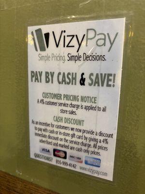 Sign posted about fees for paying with credit card