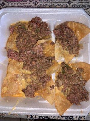 Raw pink ground beef in the Nacho Supreme