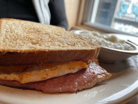 Country Ham, Egg and Cheese on Toast with a side of grits.