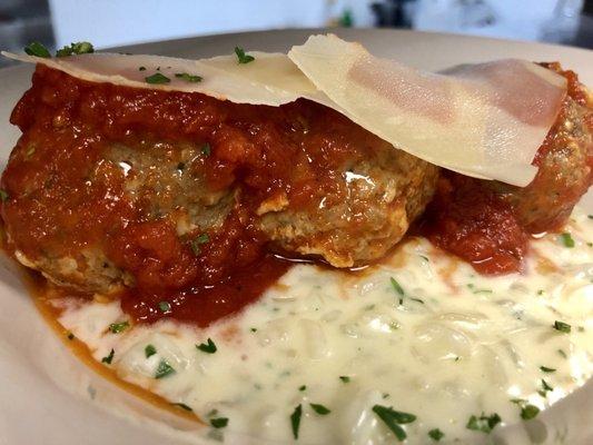 Homemade Meatballs over Creamy Risotto, topped with shaved Parmesan Cheese.