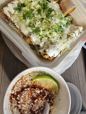 Potatoes Taquitos with Elote in cup.