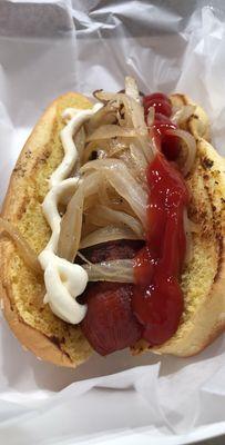 Bacon-wrapped hot dog with grilled onions