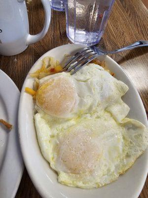 Eggs over easy with loaded Hash browns underneath