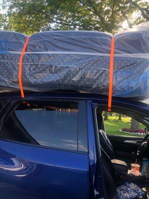 Full and queen mattress strapped to Nissan, Pathfinder with commercial straps