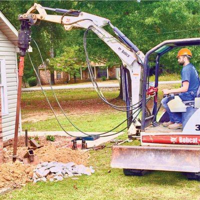 Placing a helical pier.