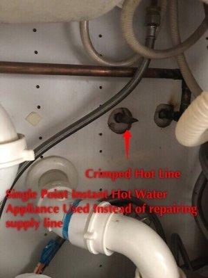 Instant hot water heater under the kitchen because the original hot water supply line was crimped shut.