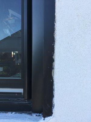 New black aluminum window trim now messed up with stucco products.