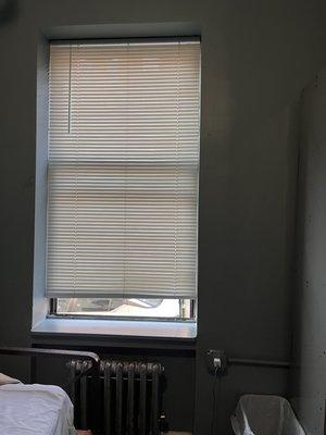 The blinds that don't go all the way down on the first level and the pen that holds it up.