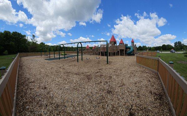 Back side of main playground area showing the swings.