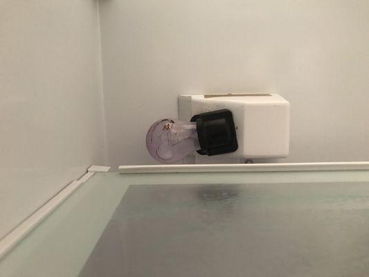 Busted lightbulb inside of fridge.