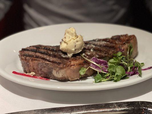 Amazing New York Strip perfectly prepared with truffle butter on top.