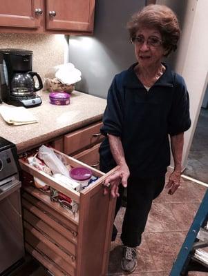 Mary showing off her new custom pullout pantry cabinet