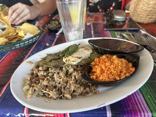 Pork Carnitas platter with sides of rice, beans