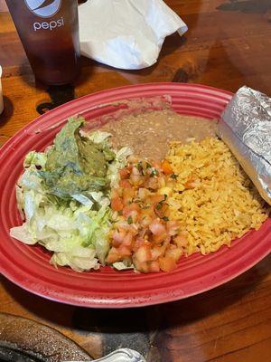 Steak fajitas with rice and beans served with tortillas.