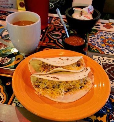 Chorizo & egg breakfast tacos topped with fresh salsa & cheese, with great coffee!