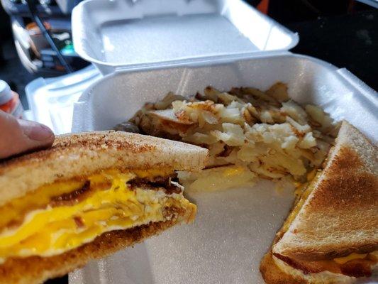 Bacon, egg, and cheese on wheat with tasty American fries