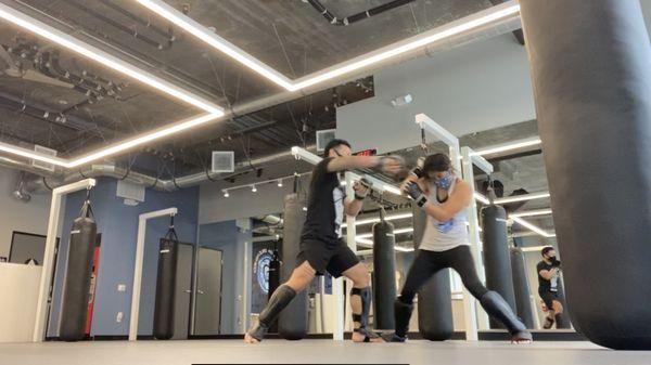 Light sparring with MMA gloves using skills learned in Fight class.