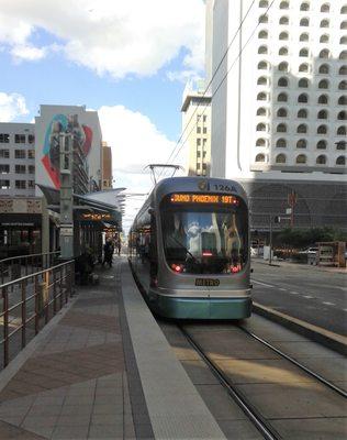 Couldn't resist getting a photo of this light rail train and that goofy white building after getting a donut at Dunkin' just beyond.