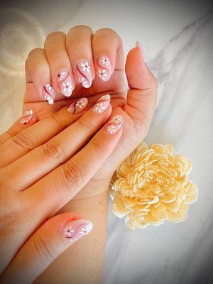 Some flowers and lines designs on almond nails