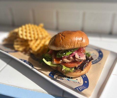 Seared Ahi Tuna Sandwich: Seared and sliced ahi, miyagi sauce, avocado, tomato, pickled onion, mixed greens tossed in wasabi vin.