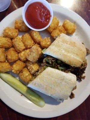 Cheesesteak sandwich on hoagie with tater tots