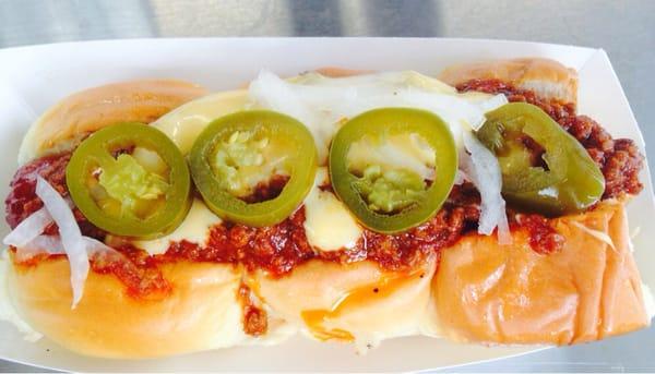 Chili hot dog with jalepenos.