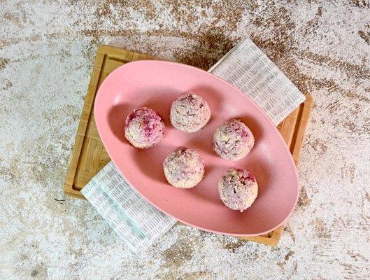 Raspberry Cheesecake Protein Bites, a gluten-free snack that has 25g of protein per container