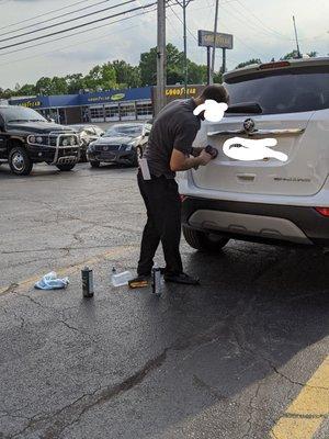 Fixing their poor work in the parking lot.