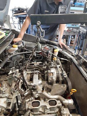 Esteban looking over an engine before it is lifted out of the engine area.