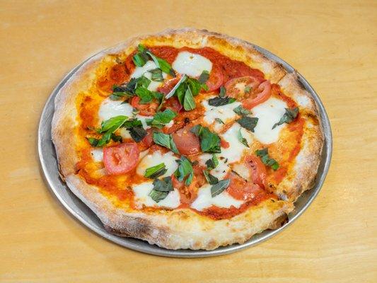 The Perfect Margherita has a port wine sun-dried tomato sauce, roma tomatoes, fresh mozzarella and basil