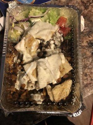 Chicken and lamb over rice mix with a side salad, knaan (I think)bread and white sauce