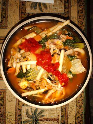 Seafood stew of ingredients at Koa Mart: fresh seafood mushrooms, baby bok choy, seafood noodle soup, mixed seafood, & a topper of sambal.