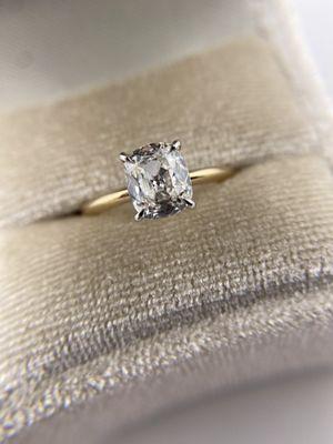 Custom made engagement ring featuring a GIA certified 1.24 carat H VS2 modern antique cushion cut in 14k white and yellow gold.