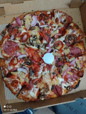 Large pepperoni, salami, pineapple, mushroom, tomato and red onion pizza nice and crispy cooked perfectly.