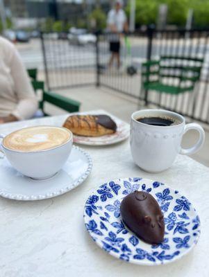 cappuccino, chocolate croissant, black drip coffee, and a chocolate mouse