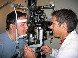 Doctor Davidorf performing an eye exam. (Taken from www.prweb.com)