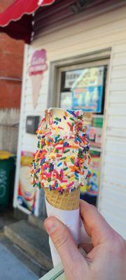 Small twist cone dipped in rainbow sprinkles