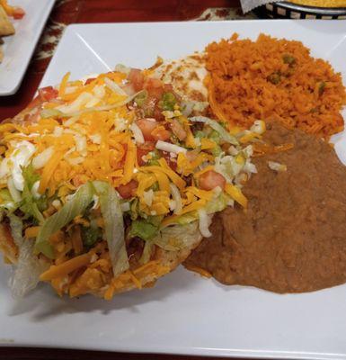 A lunch plate with a $2 upcharge for dinner - a tostada and a soft taco with beans and rice.