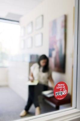 'People Love us On Yelp' Sticker displayed at Ana's office