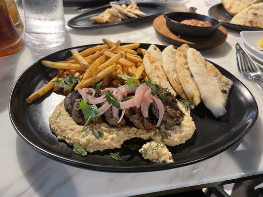 Greek spiced (not spicy) Meatballs over fresh hummus. I ordered a second one to go for lunch the next day.