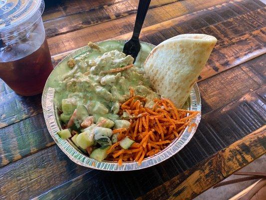 Hummus bowl with chicken, w/carrots, cucumber & tomato topping and creamy jalapeño feta sauce on top.