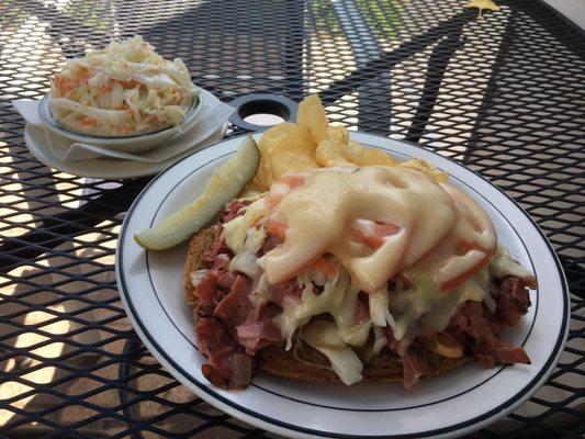 Open faced "Destroyer" sandwich with side of chips and coleslaw.