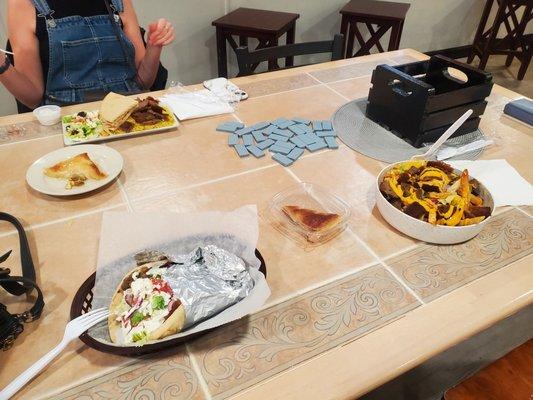 Gyro sandwich, loaded fries, baklava, gyro rice plate.