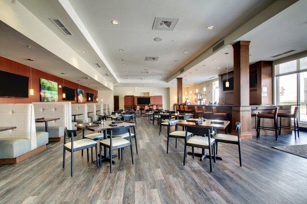 Suite Fire Bar + Grille features cozy seating areas, a community table and multiple flat screen TVs.