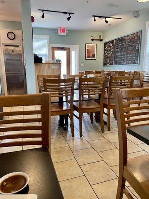 Interior of restaurant from back looking towards front entrance. Clean, decent number of tables for how small a size this place is