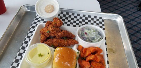 Checking out the chicken tenders along with glazed carrots broccoli salad and banana pudding