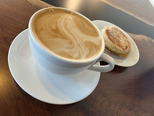 Almond milk latte and egg and cheddar breakfast sandwich