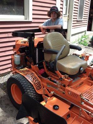 Forrest leaning on new Scag diesel Turf Tiger.