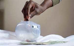 A person filling up their piggybank