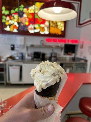 Cookie Dough ice cream in a chocolate dipped waffle cone.